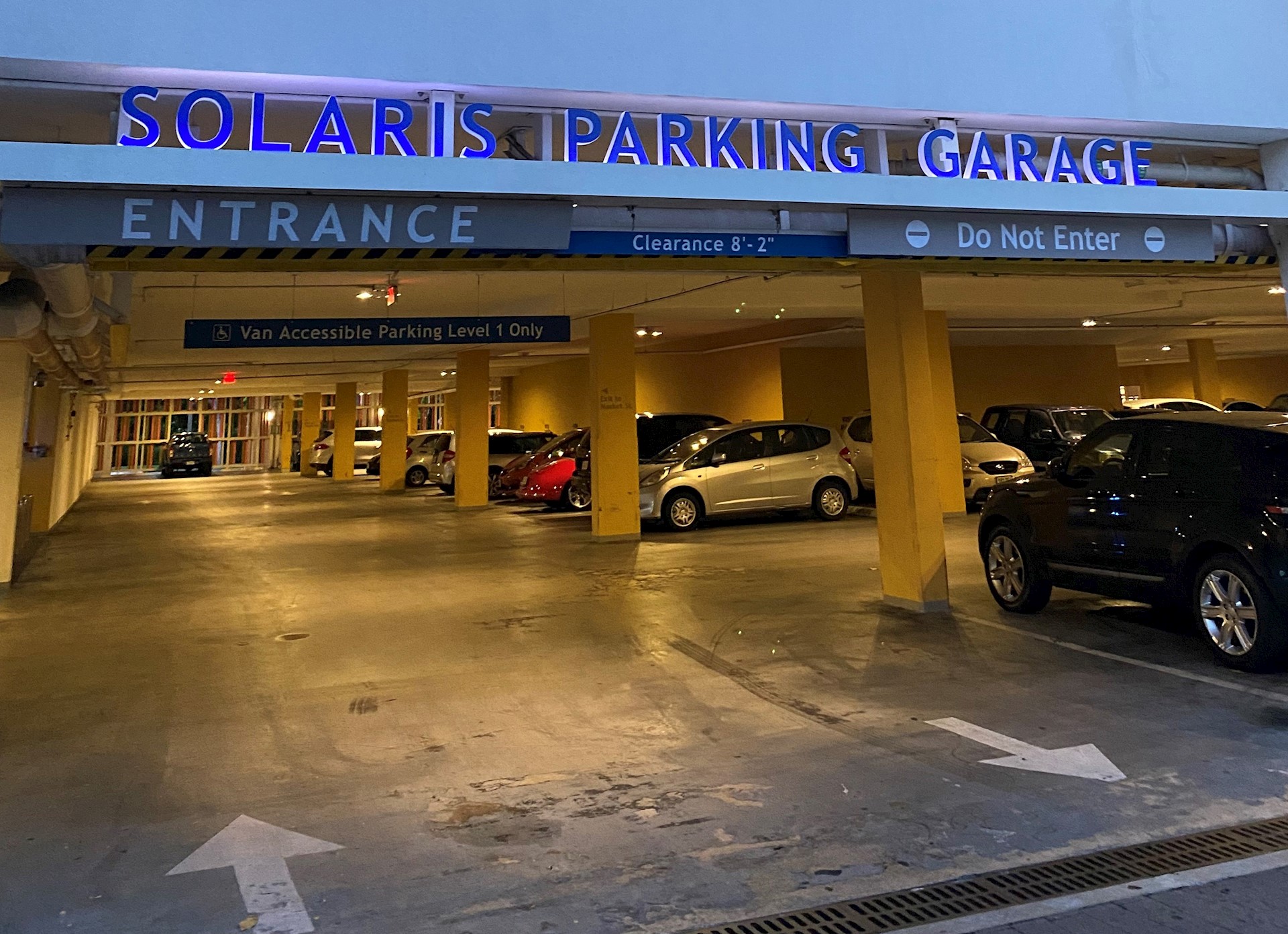 Parking garage entrance lit by yellow lighting