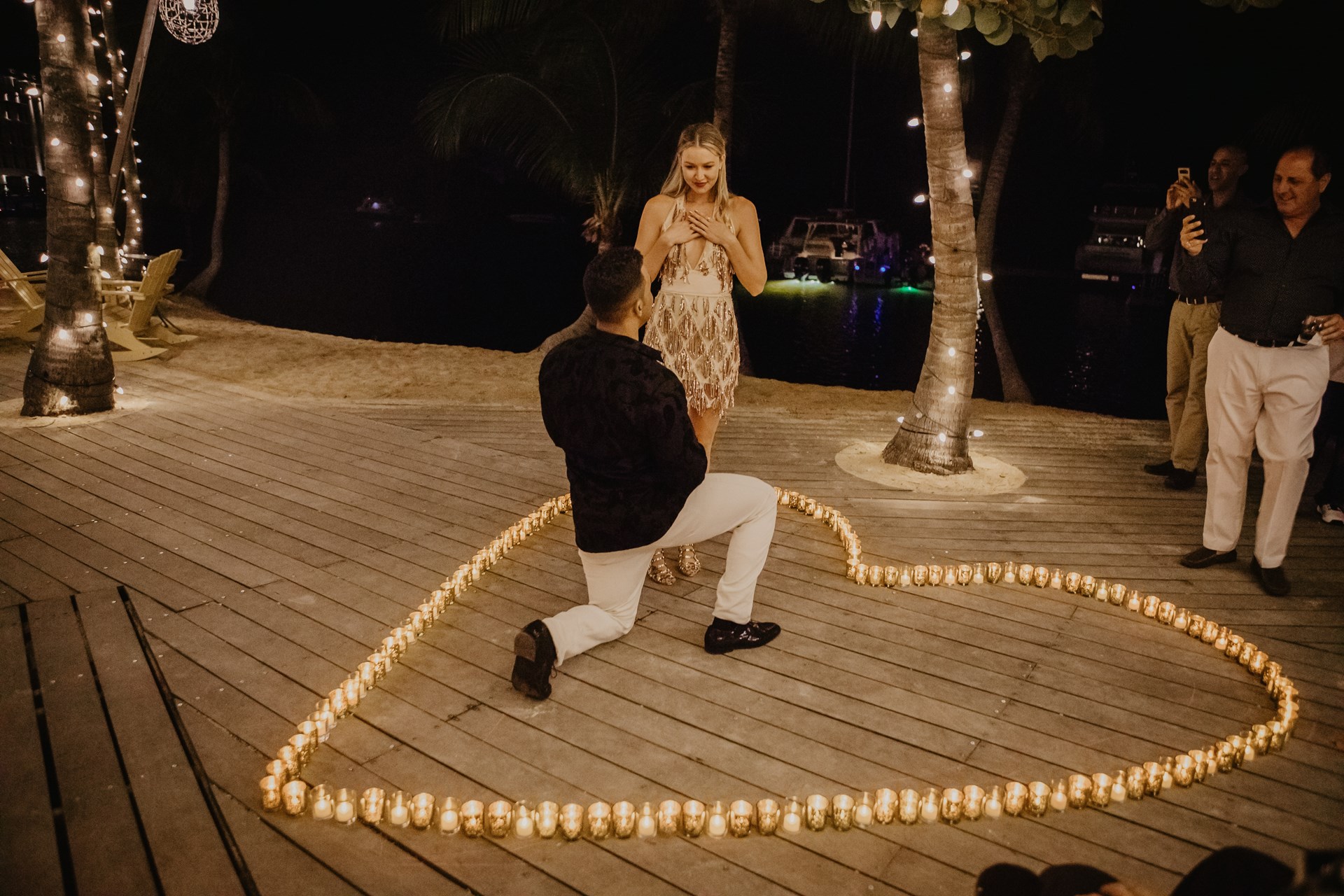 Man proposes to woman in a heart made of candles