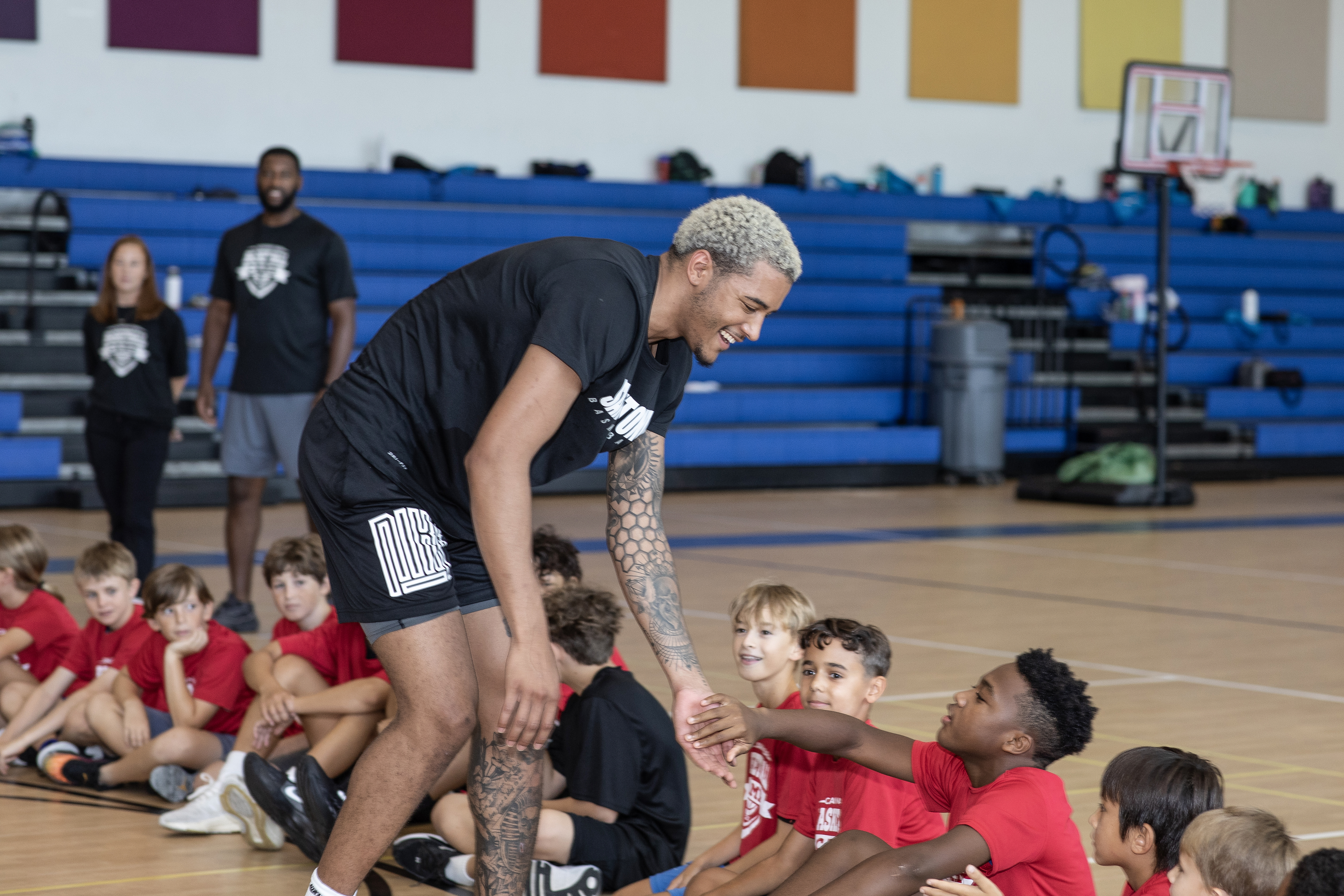 Basketball player interacting with young people