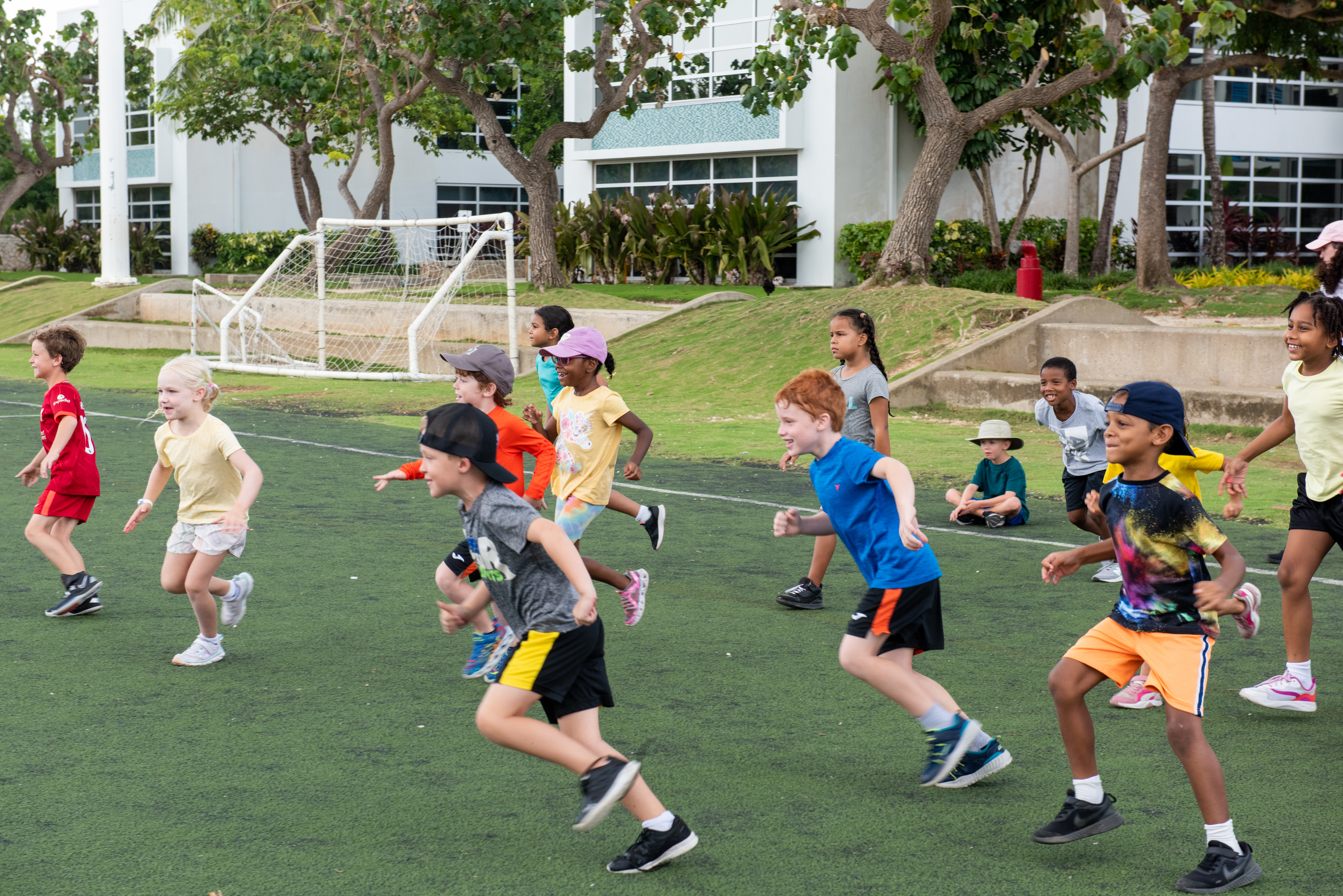 Kids play on sports field in Camana Bay