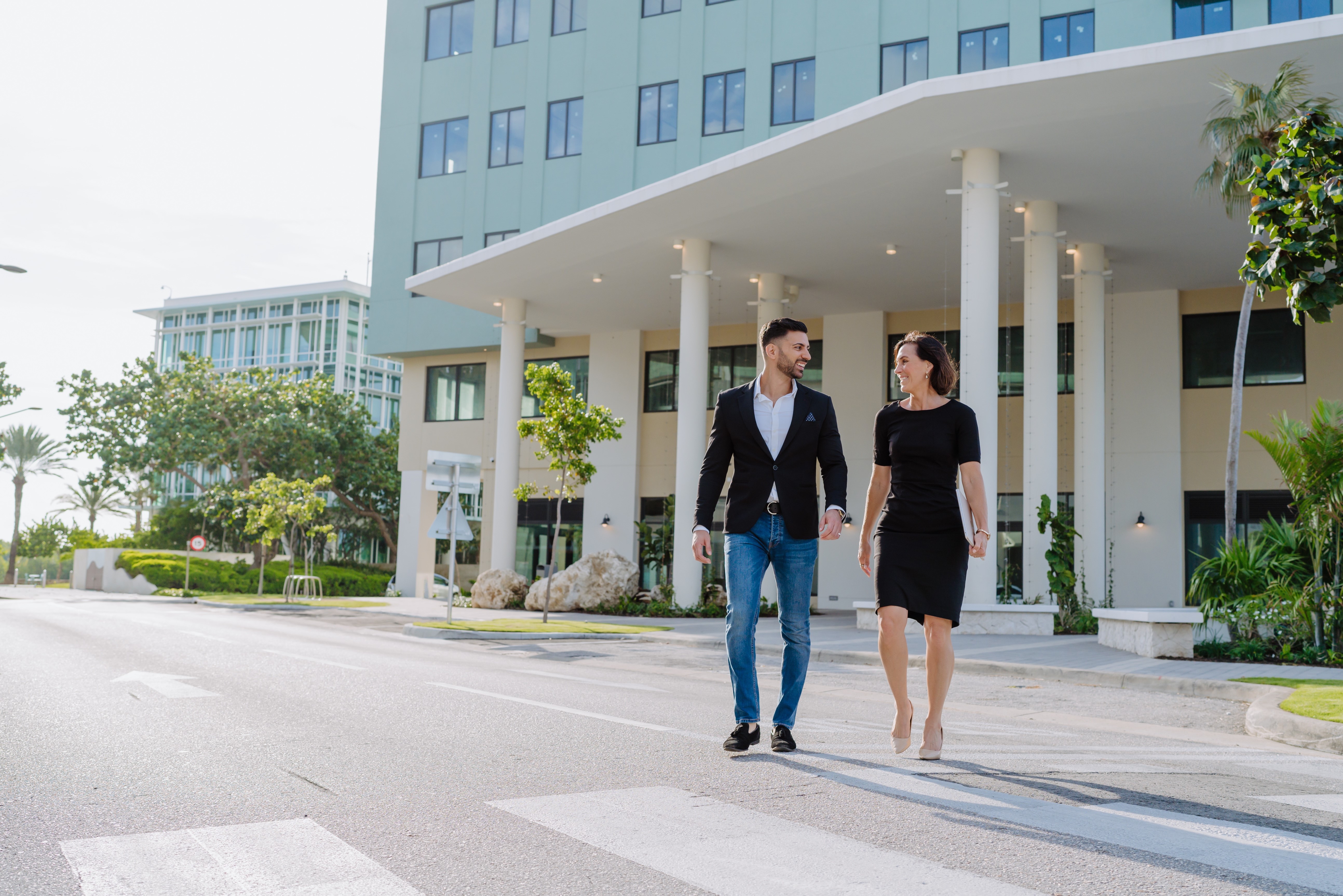 Man and woman walking across the street.