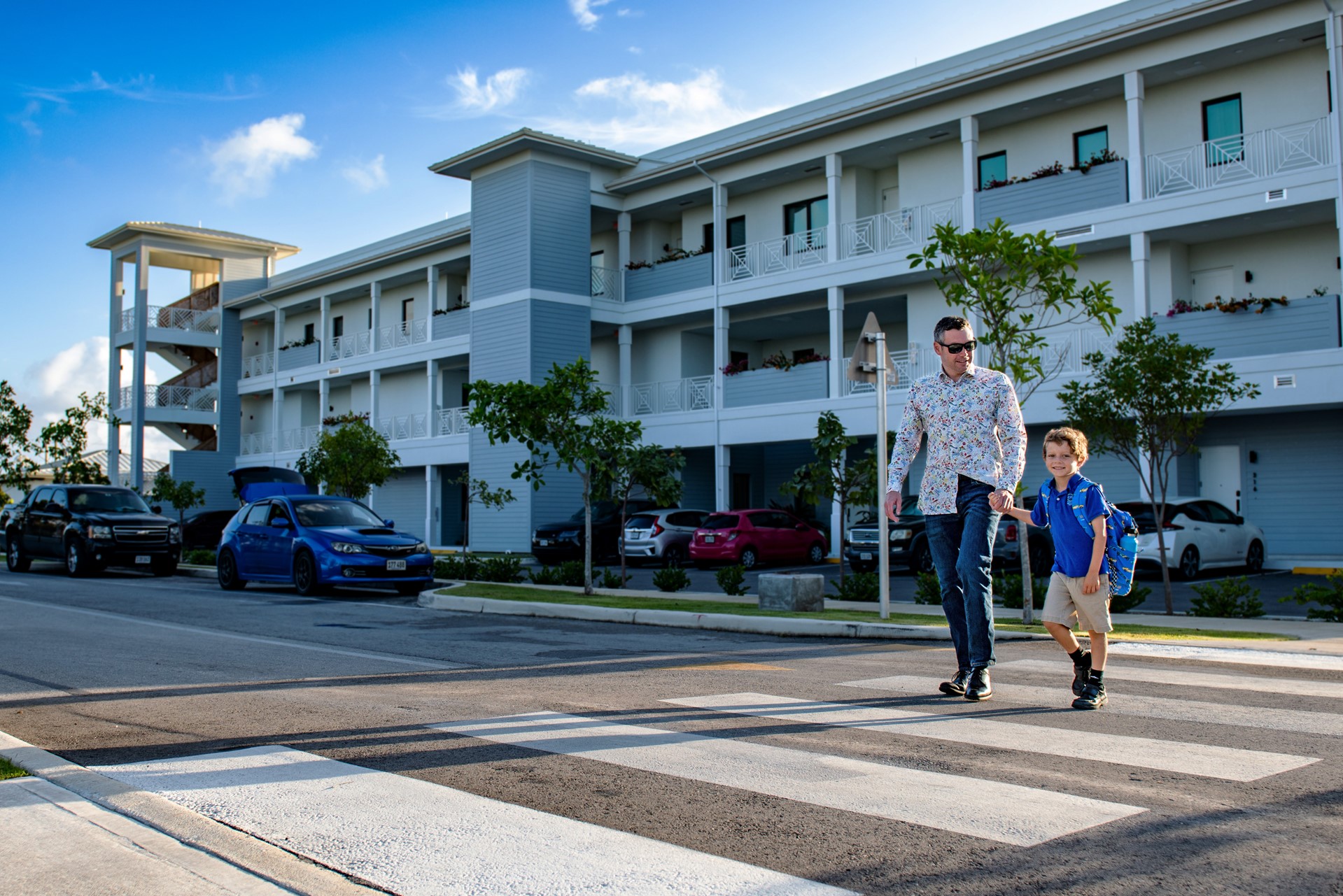 father and son crossing the pedestrian walk