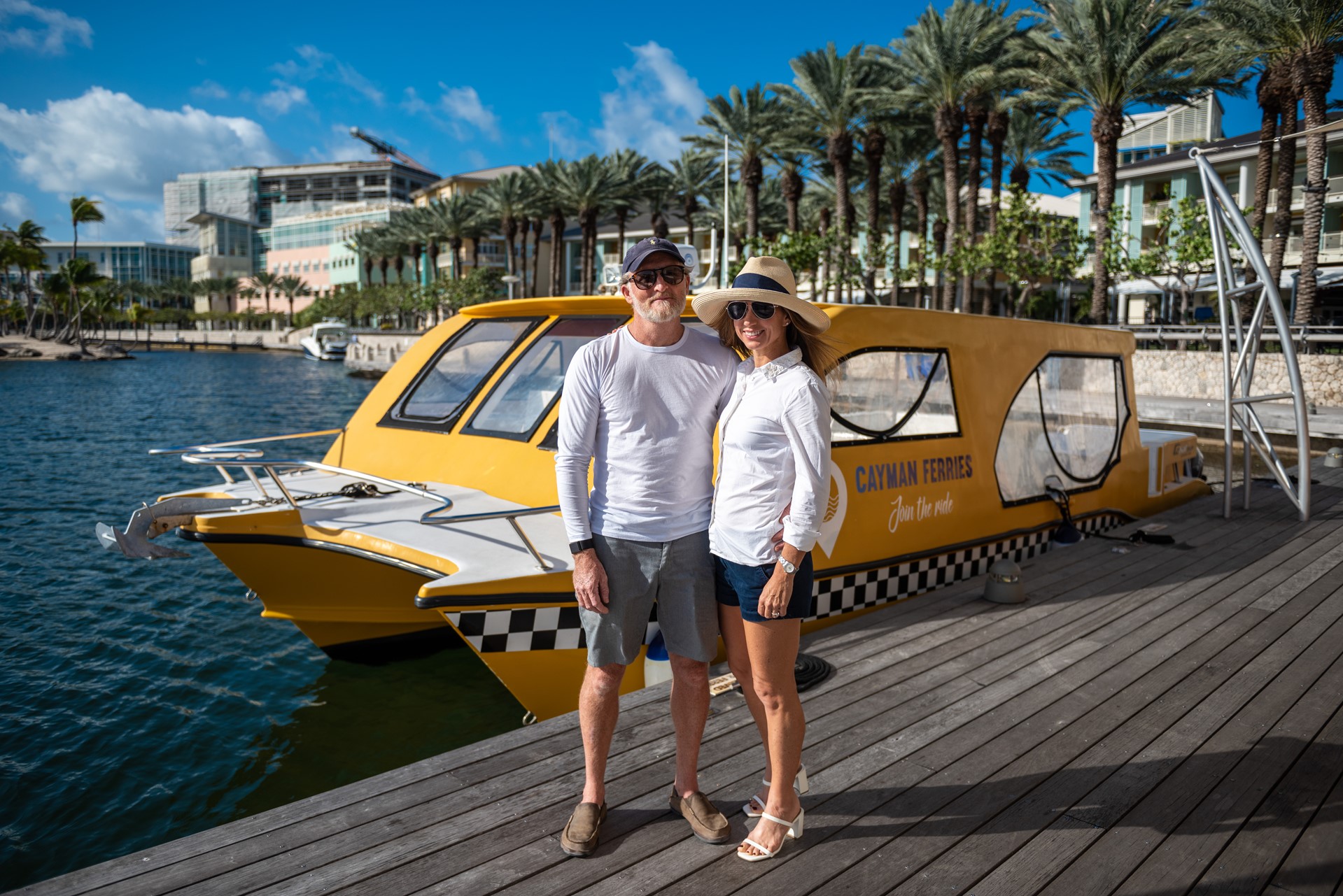 man and woman in front of a ferry in the harbour