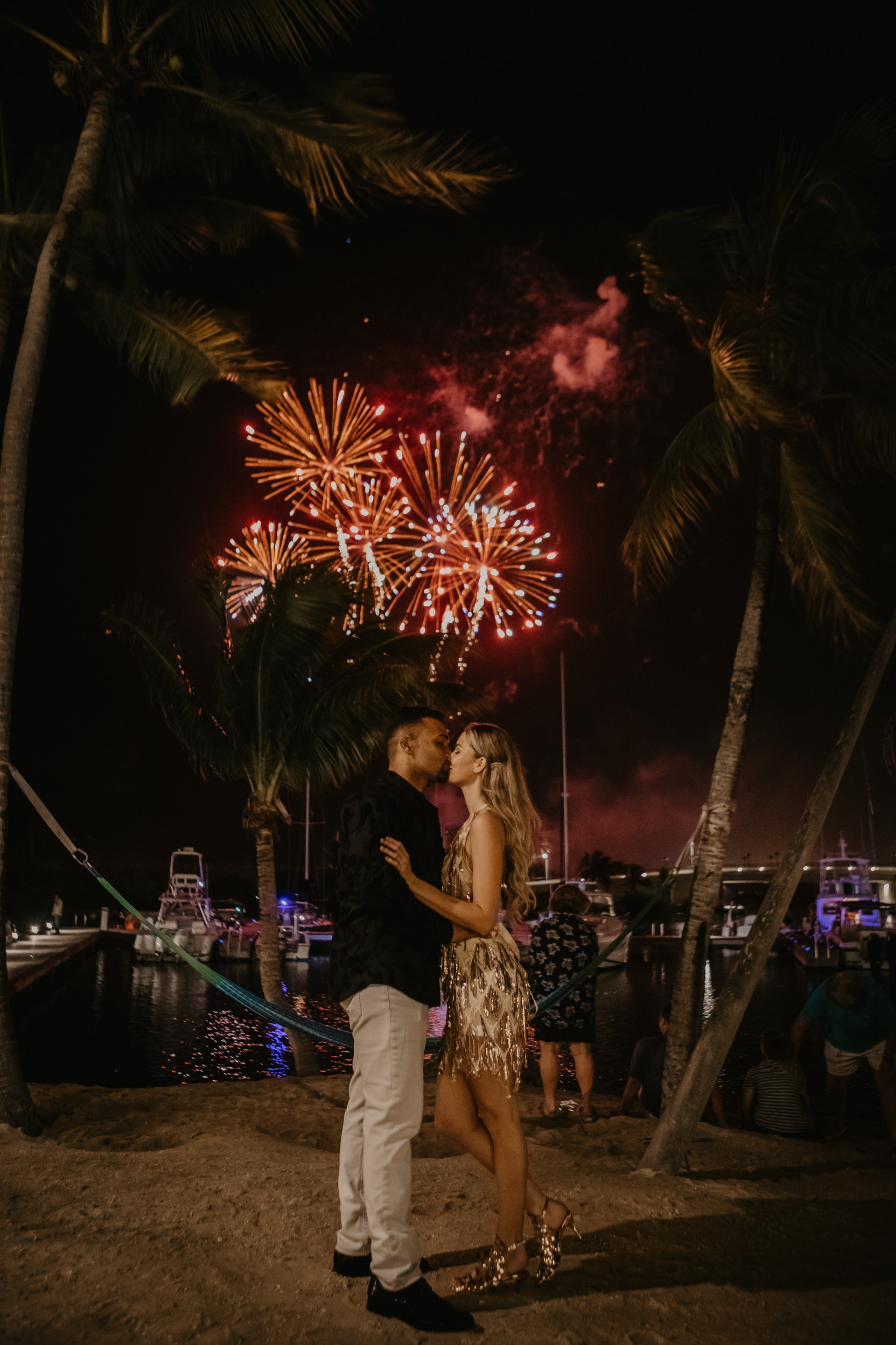 Couple kiss in front of fireworks