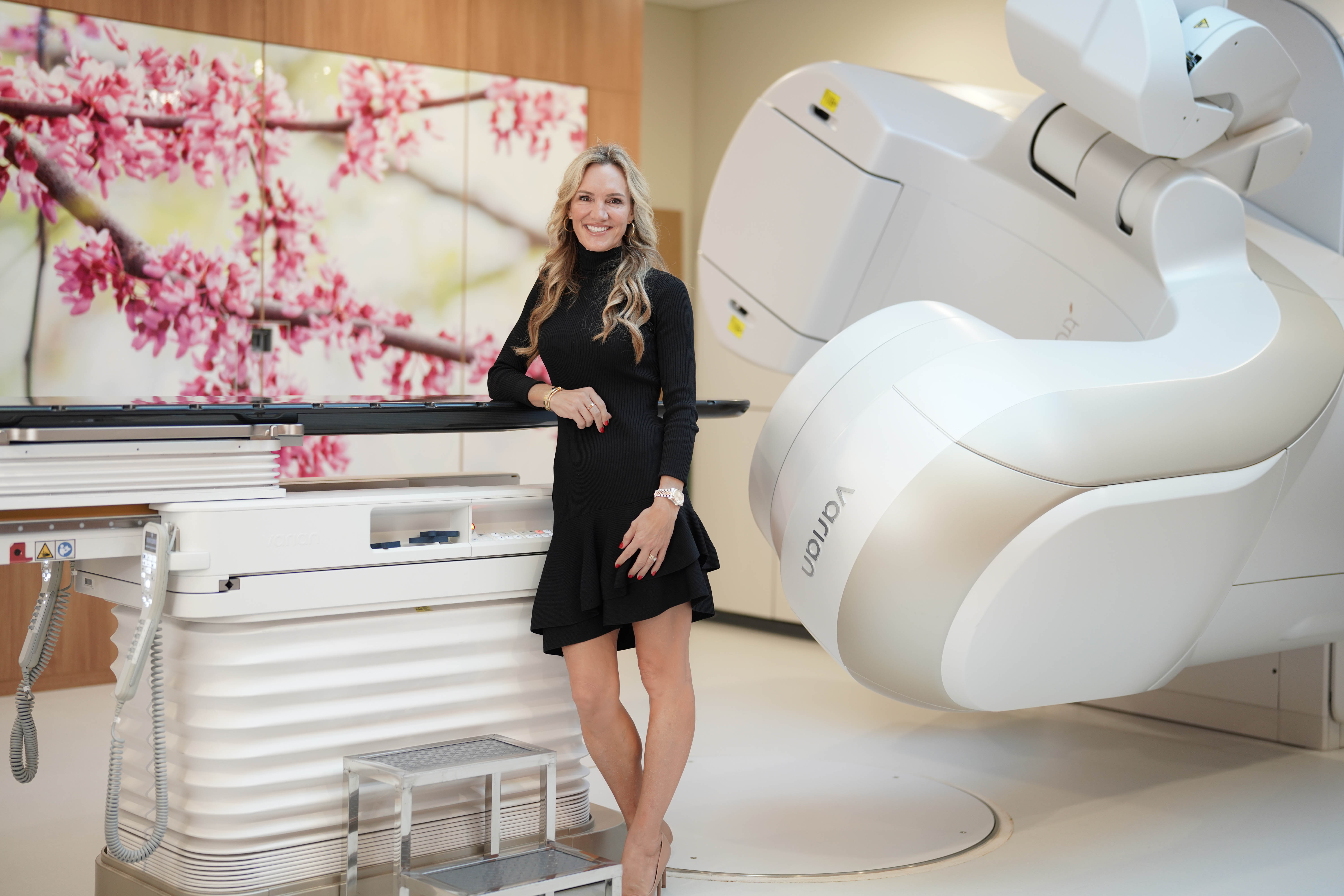 Woman stands in front of medical machine