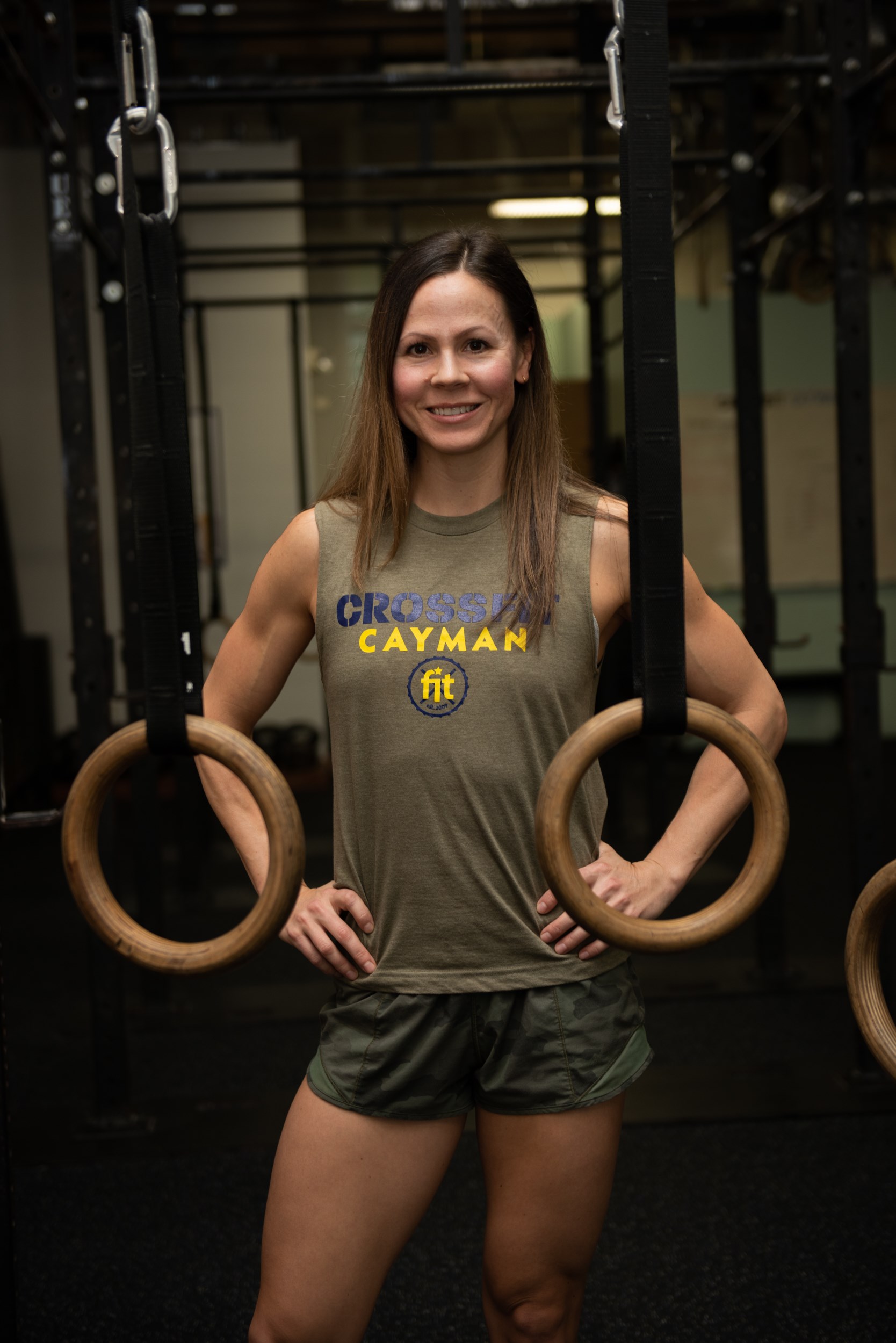 Woman poses for camera in Crossfit gym