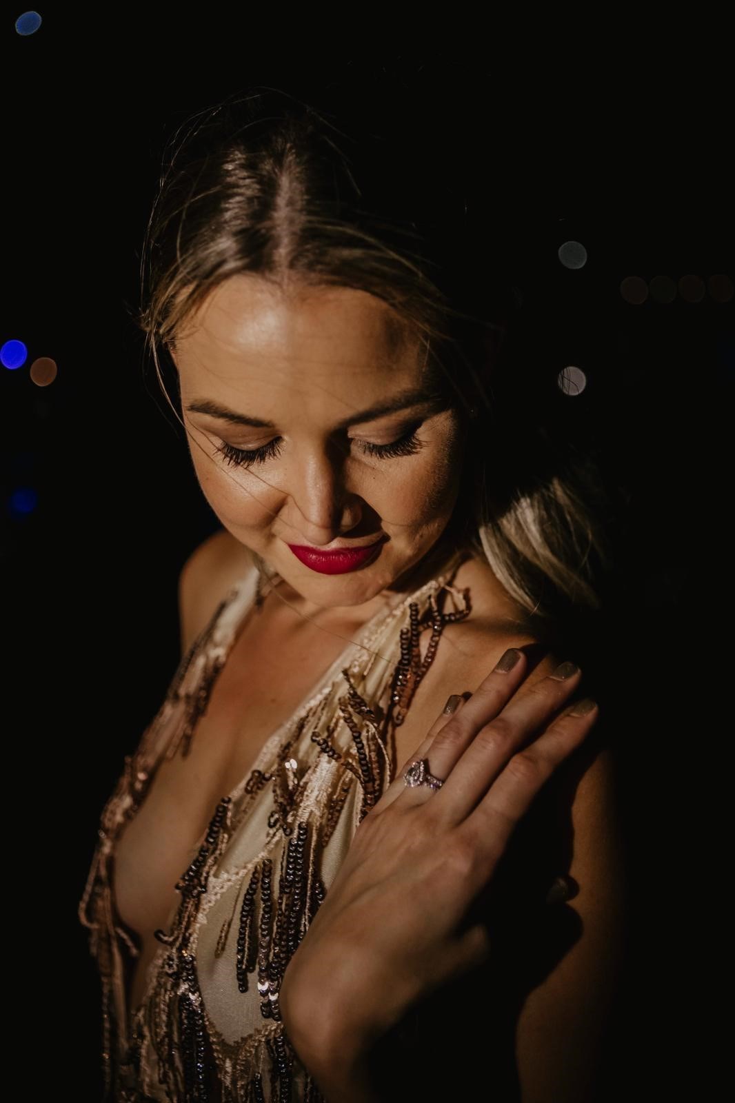 Woman looks down at engagement ring