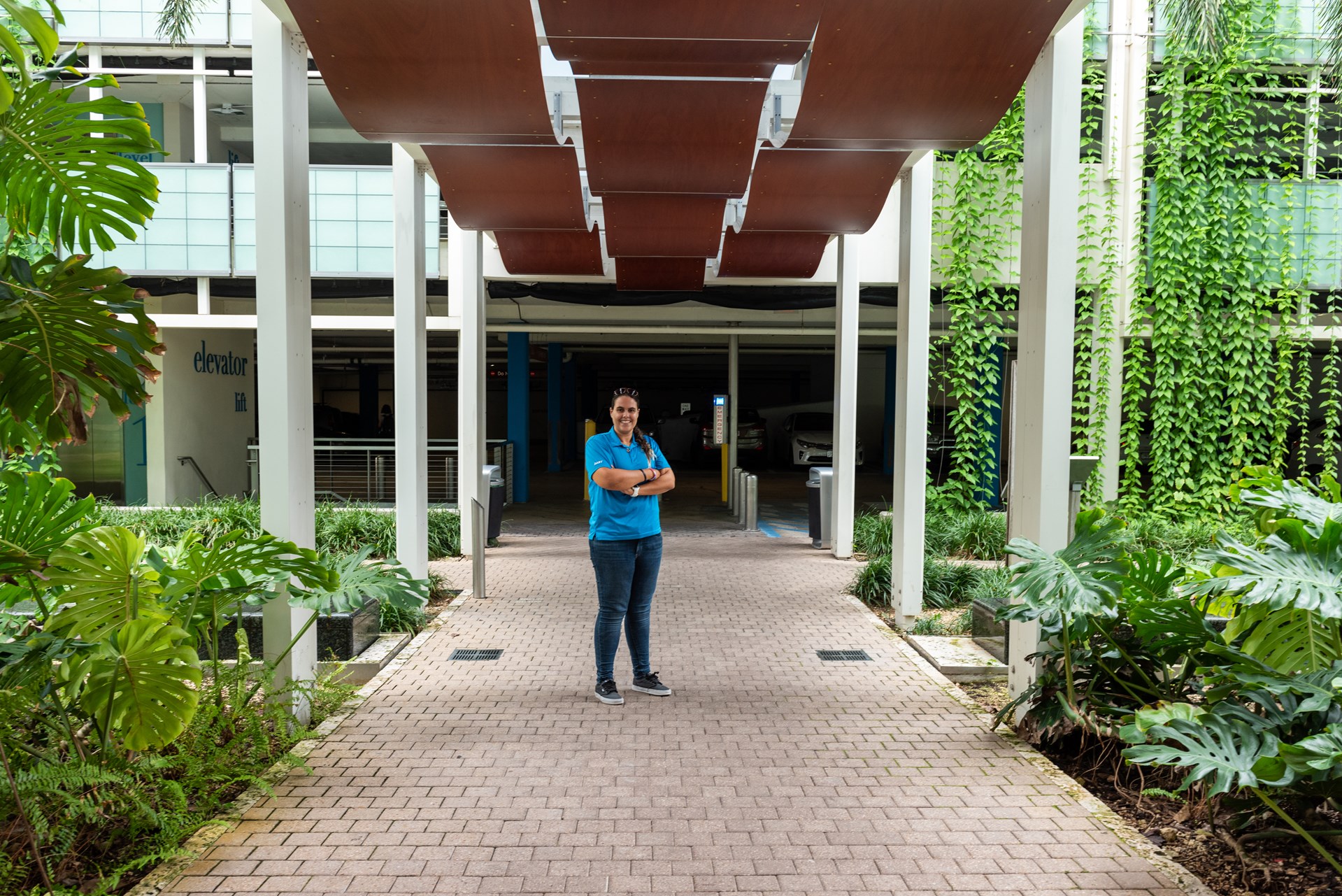 Girl in blue shirt with her arms crossed