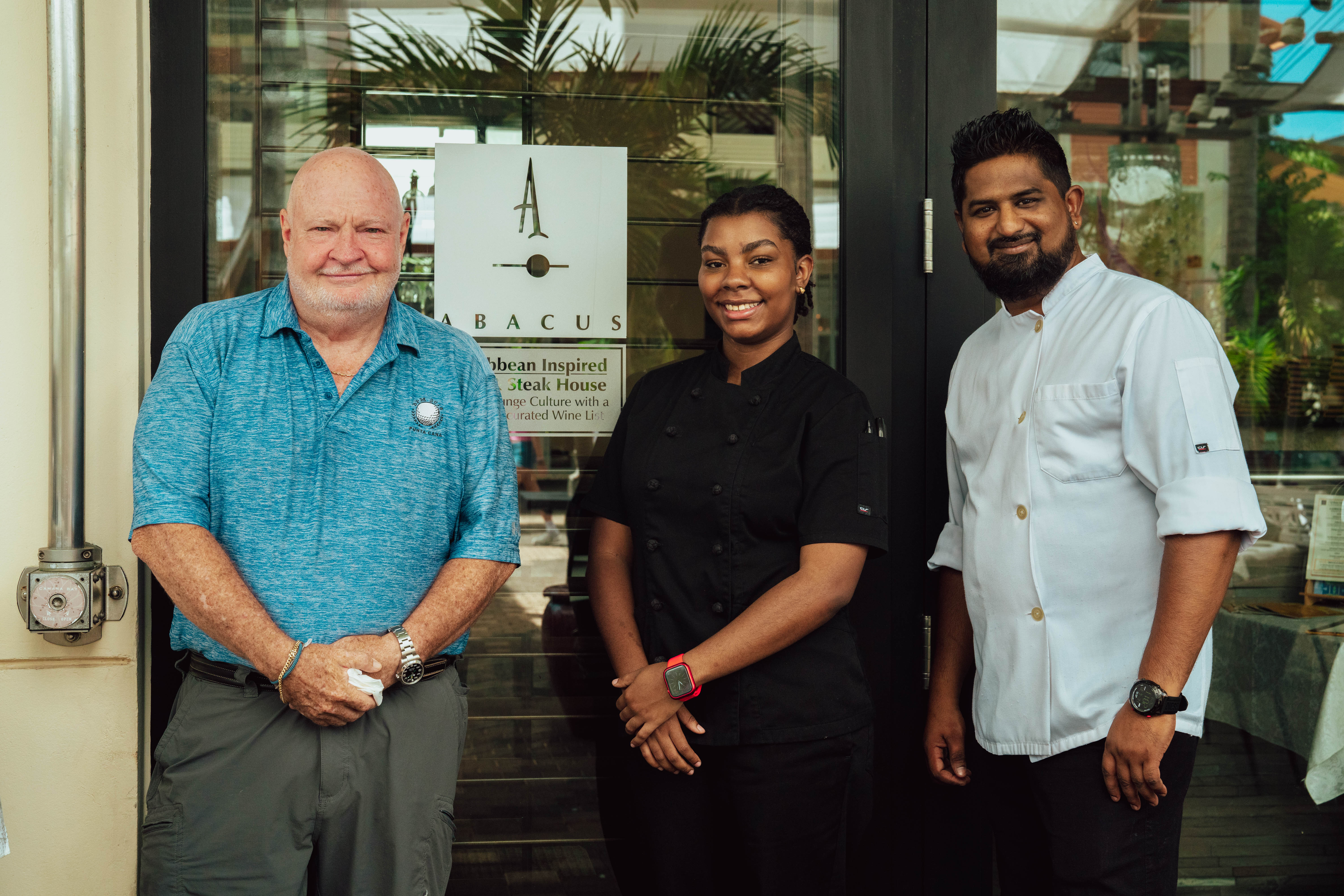 Chefs stand outside restaurant