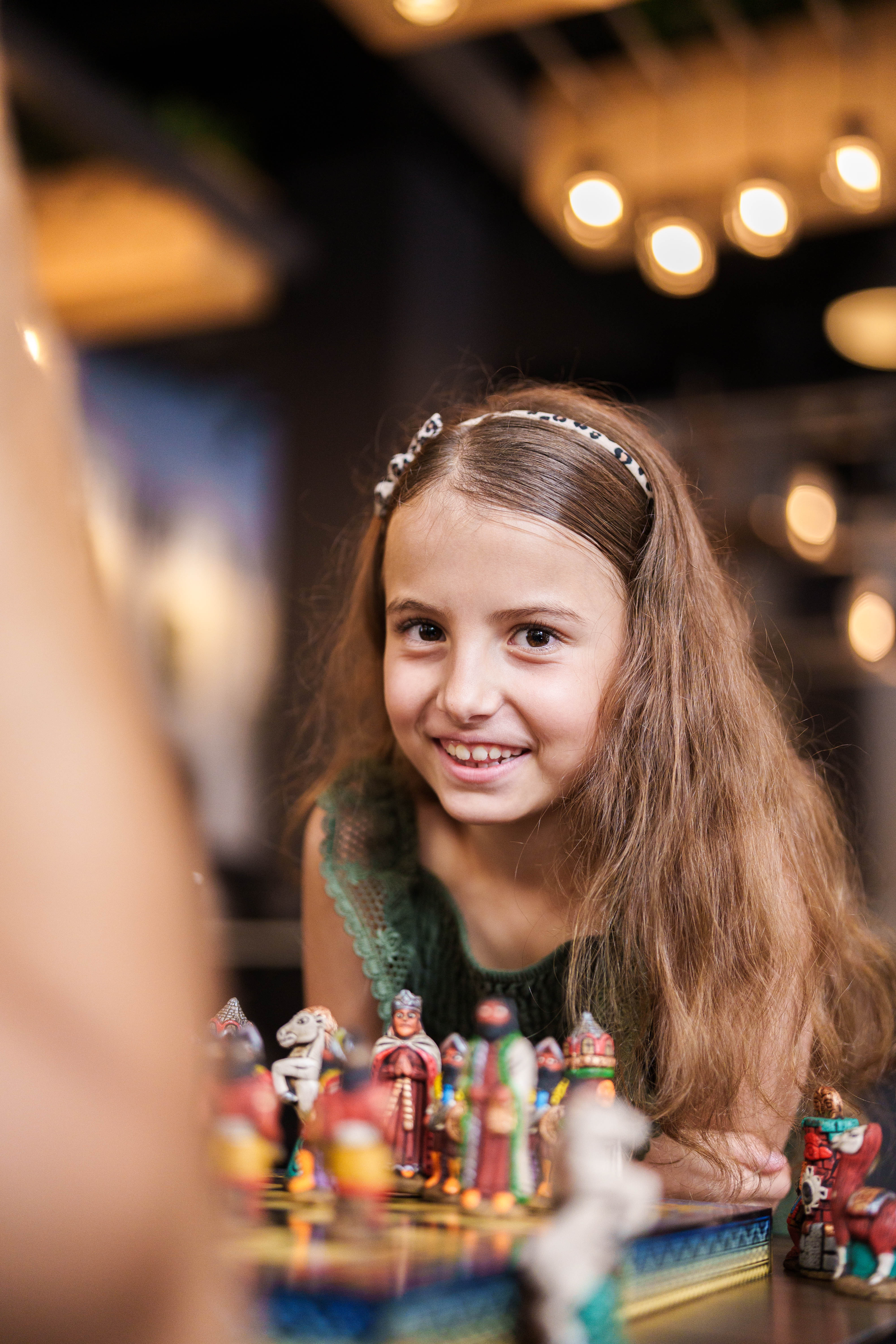 girl in front of chess board