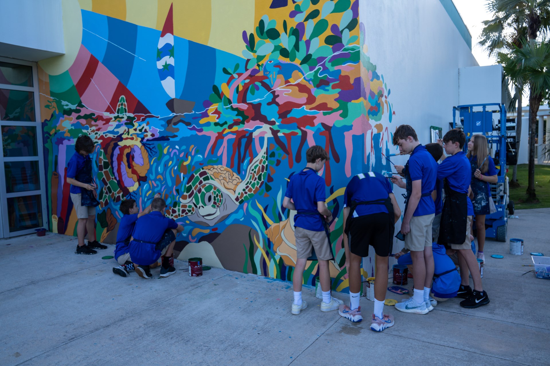 Students painting mural on wall