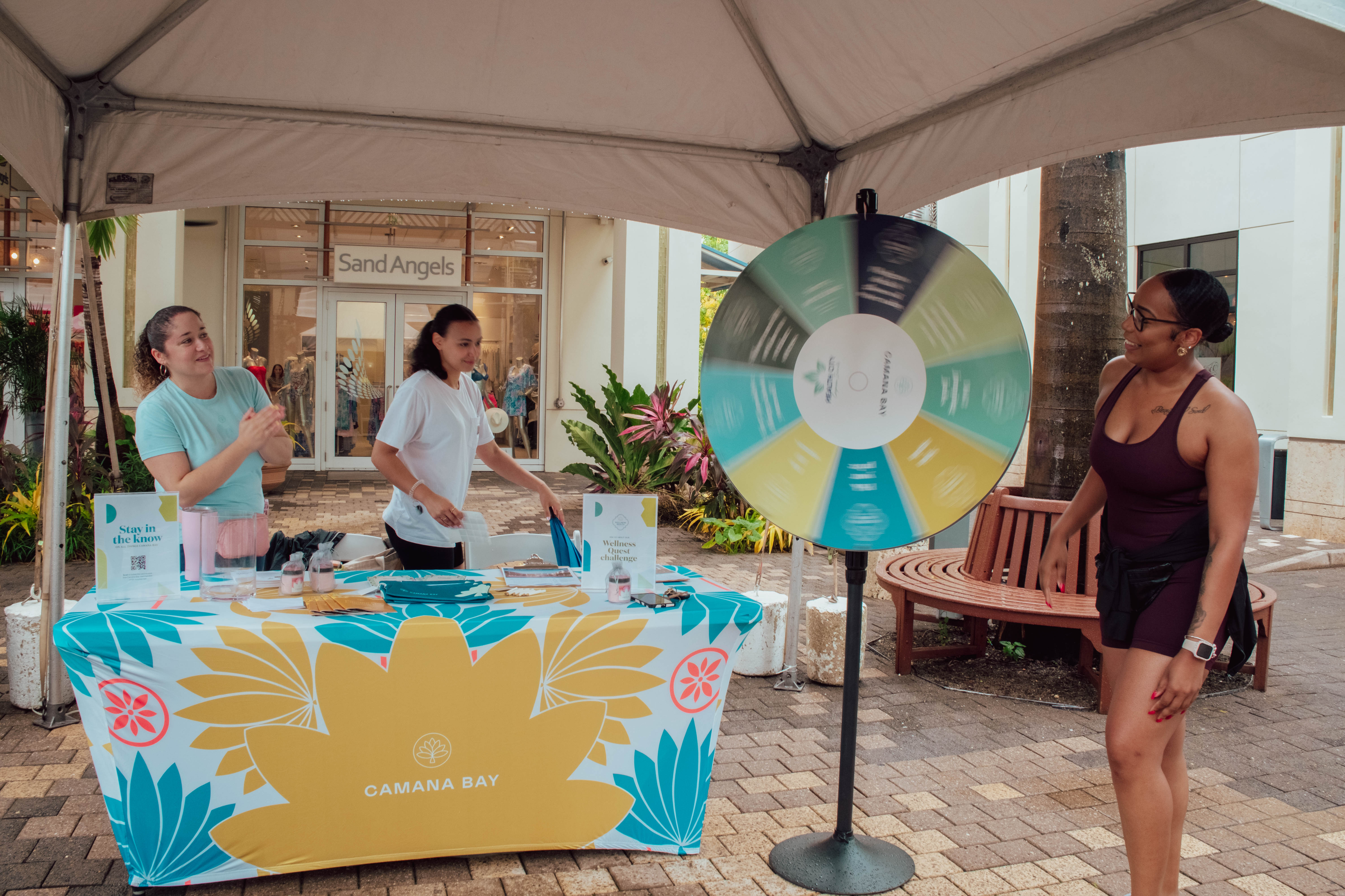 Woman spinning wheel at booth