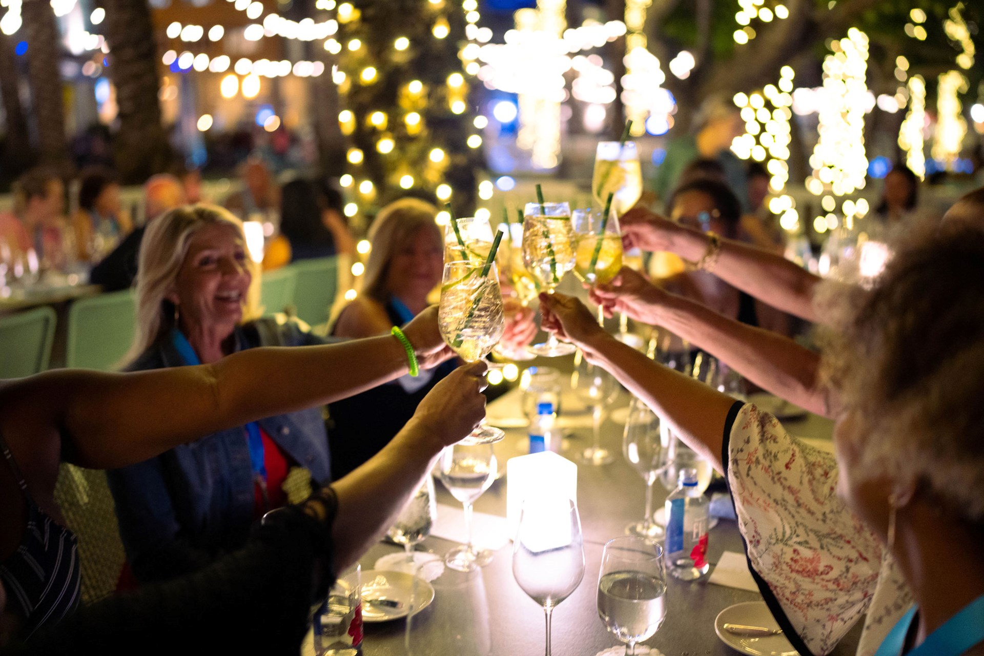 Group of people clinking drinks